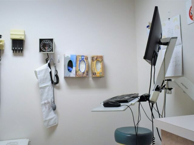 Clinic manager reviewing patient acquisition cost data with a doctor in a modern medical office