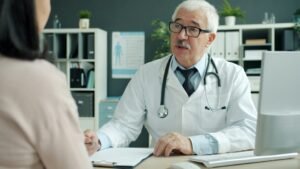 Clinic manager reviewing patient acquisition cost data with a doctor in a modern office
