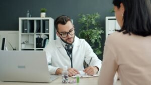 Clinic manager reviewing patient reviews and online reputation on a laptop in a modern medical office