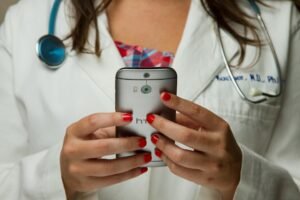 Clinic coordinator replying to an international patient inquiry on a smartphone